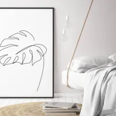 Gerahmtes Blatt-Linienkunst-Bild neben einem schwebenden Bett.