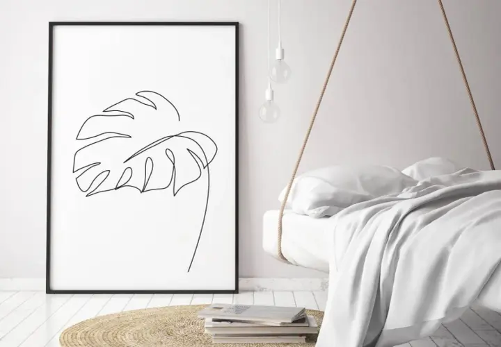 Gerahmtes Blatt-Linienkunst-Bild neben einem schwebenden Bett.