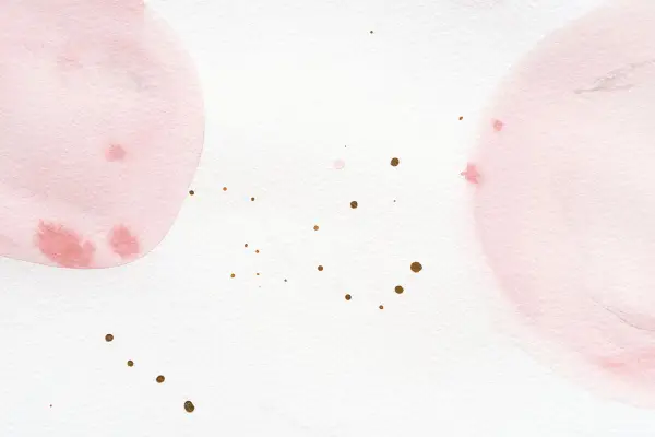 Sanfte Aquarellkreise in Rosa und Weiß mischen sich. Kleine goldene Tupfer verteilen sich auf dem Papier.
